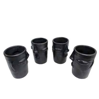 Vasos de barro negro con diseño de cara